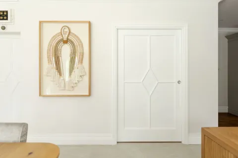 A wall with a painting and a Portman pocket door system